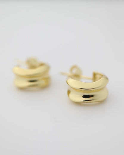Gold hoop earrings on a white background