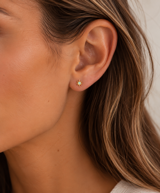 Opal Star Studs on female model ear