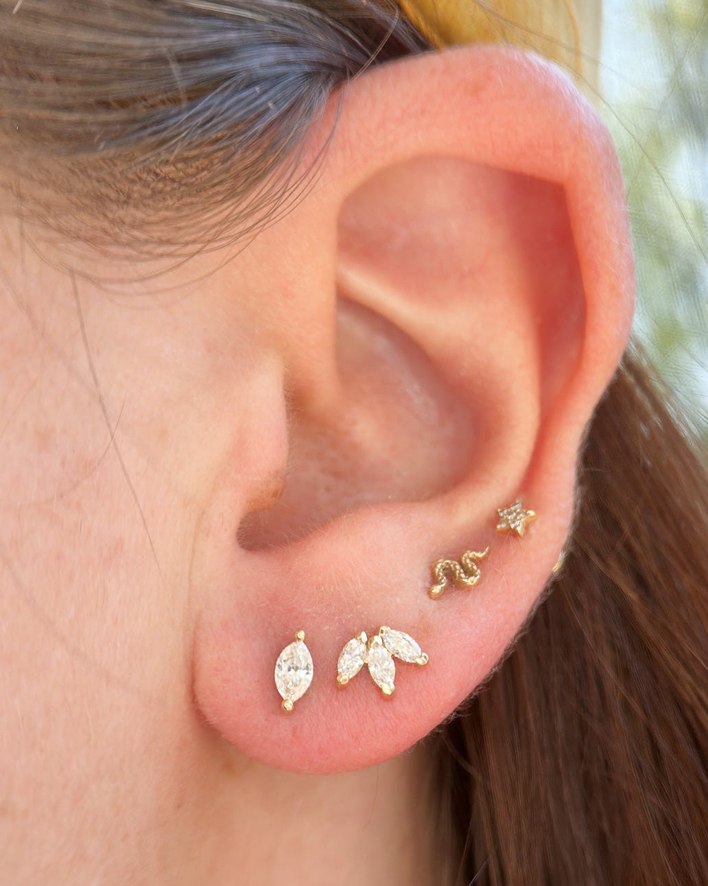 9kt gold diamond lotus earrings styled for everyday wear in female ear stack
