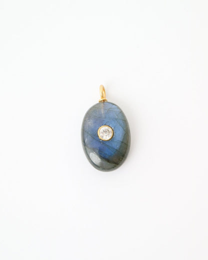 Eclipse Labradorite Pendant featuring a polished oval labradorite gemstone with natural blue flashes, a bezel-set cubic zirconia, and a gold plated sterling silver bail on a white background.