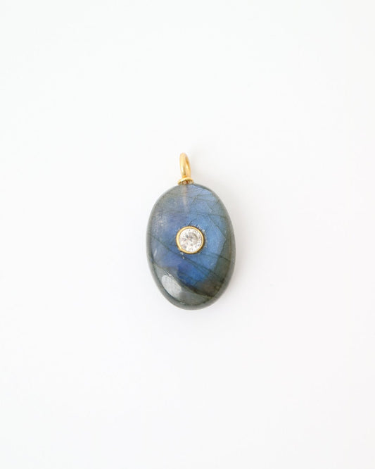 Eclipse Labradorite Pendant featuring a polished oval labradorite gemstone with natural blue flashes, a bezel-set cubic zirconia, and a gold plated sterling silver bail on a white background.