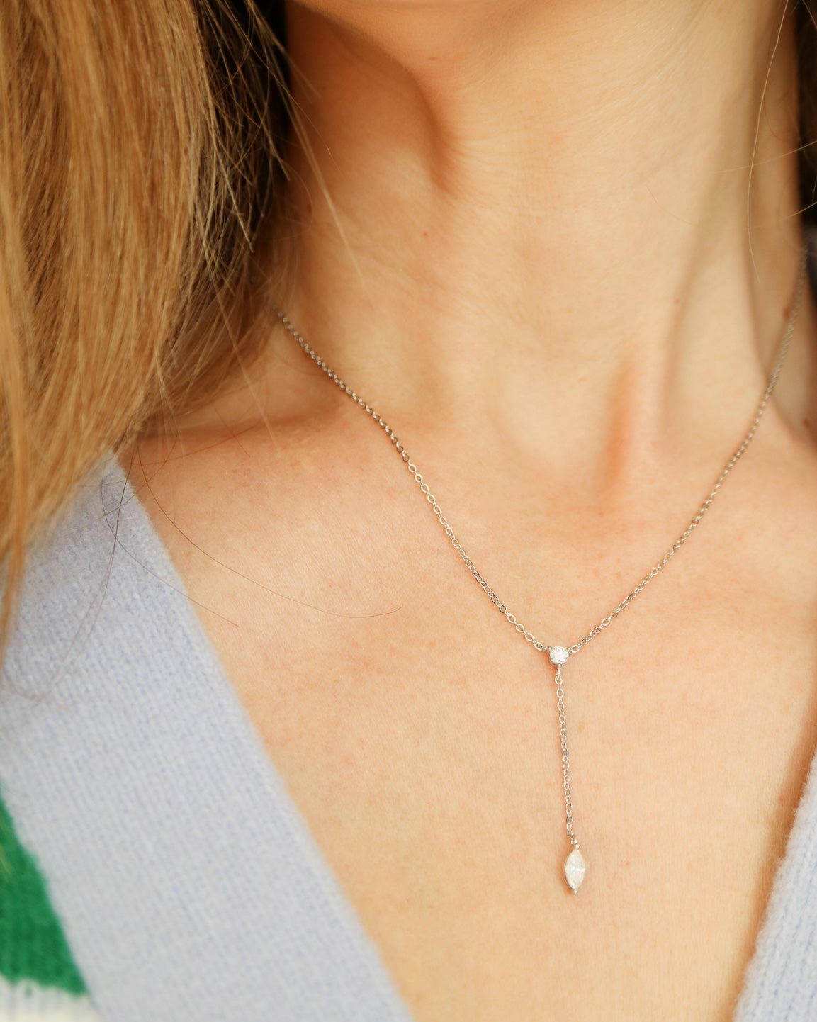 Necklace with a small pendant worn by a person