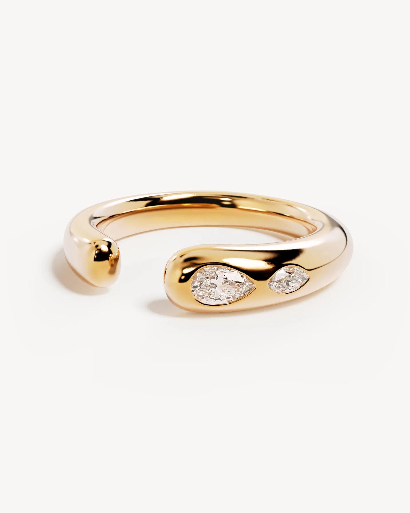 Gold ring with two small diamonds on a white background