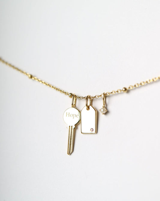 Gold Charm Necklace with key, pearl, gemstone tag