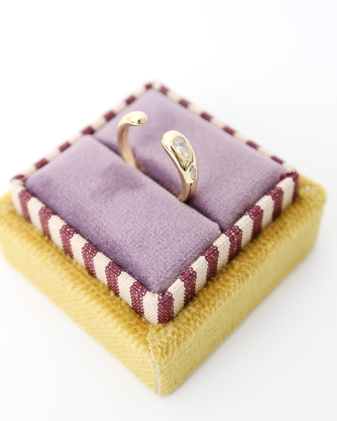 Gold-plated Elio Drop Ring with two flush-set marquise-cut moissanite stones on a sculptural curved band