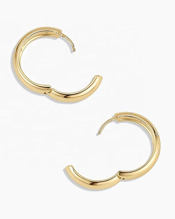 Gold hoop earrings on a white background