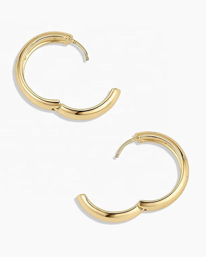 Gold hoop earrings on a white background