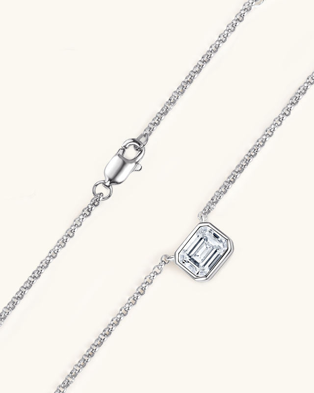 Silver necklace with a rectangular gemstone on a white background