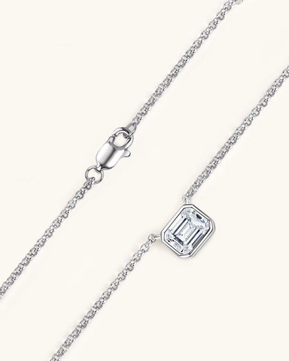 Silver necklace with a rectangular gemstone on a white background