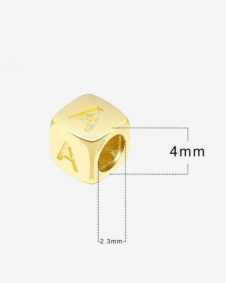 Gold bead with letter 'A' engraving and measurements on a white background