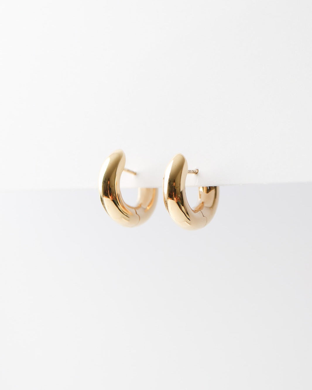 Gold hoop earrings on a white background