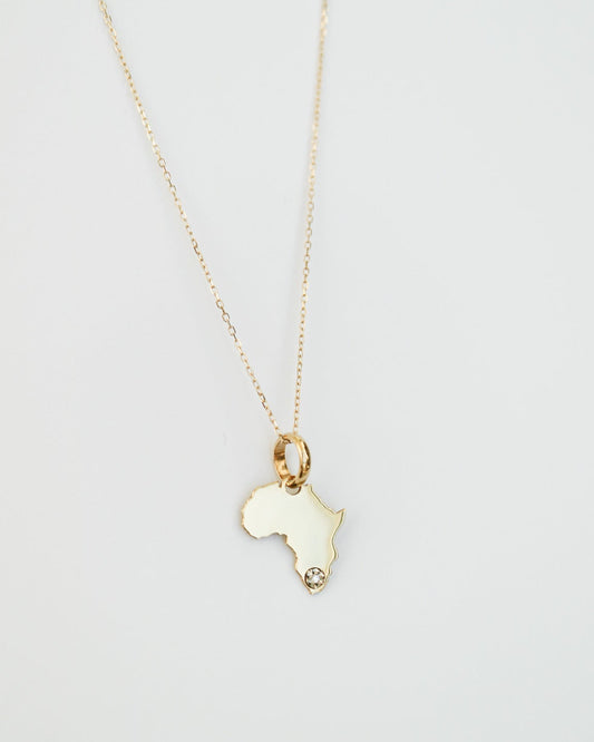 9ct Gold necklace with an Africa-shaped pendant with natural diamond on a light gray background