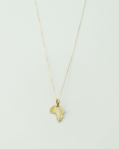 9ct Gold necklace with an Africa-shaped pendant with natural diamond on a light gray background