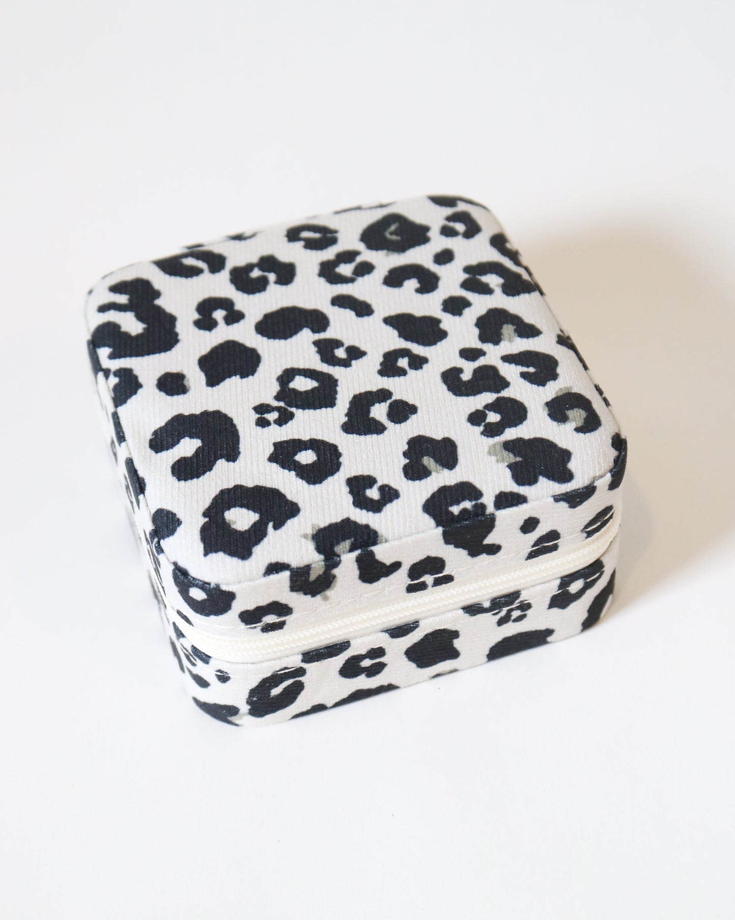 Square pillow with leopard print pattern on a white background