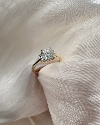 Diamond ring on a soft pink fabric background
