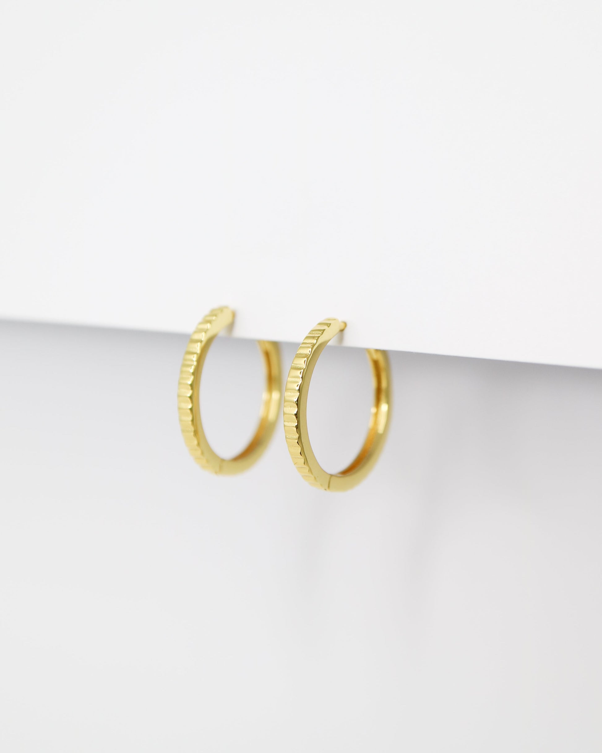 Gold hoop earrings on a white background