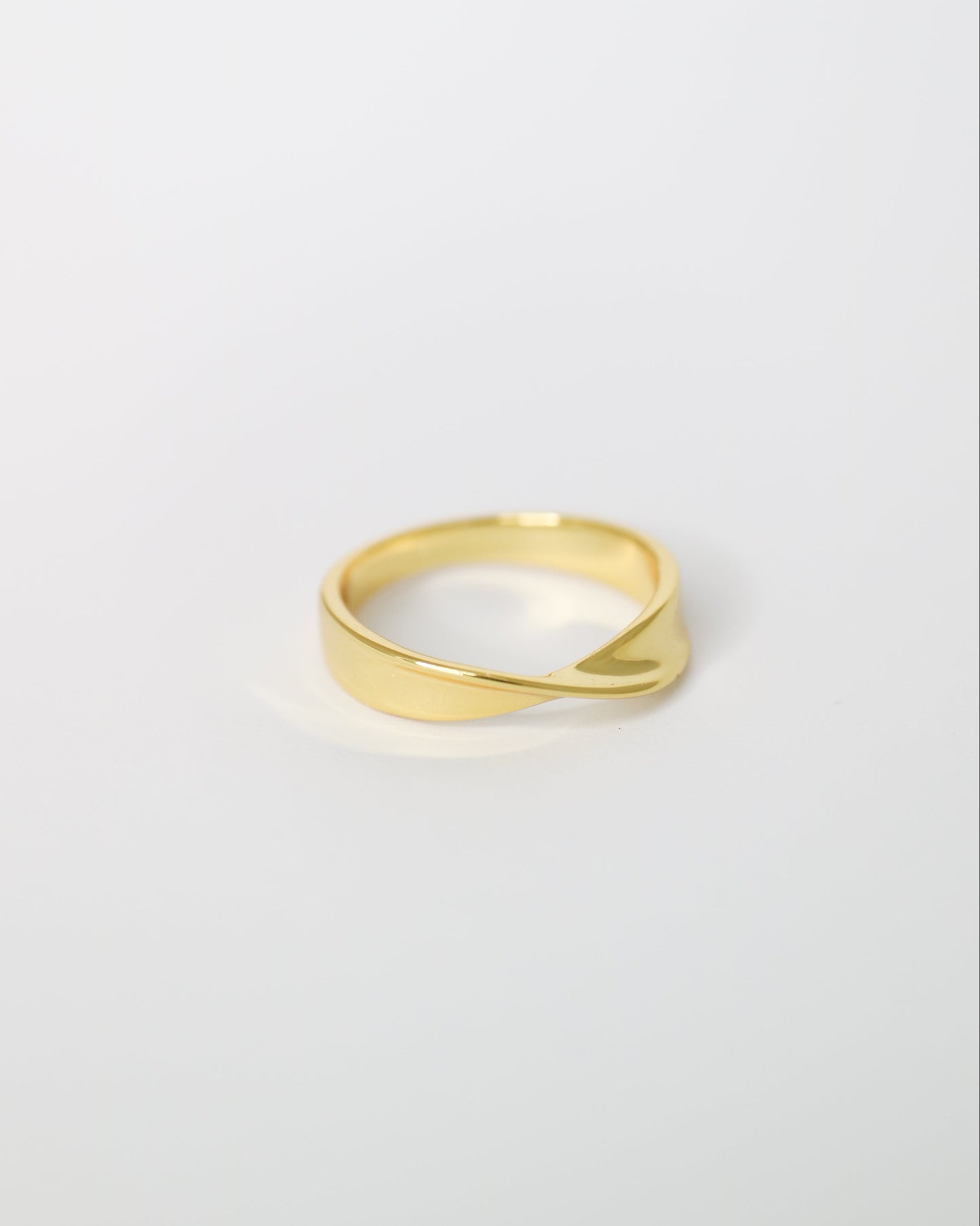 Gold ring on a light gray background