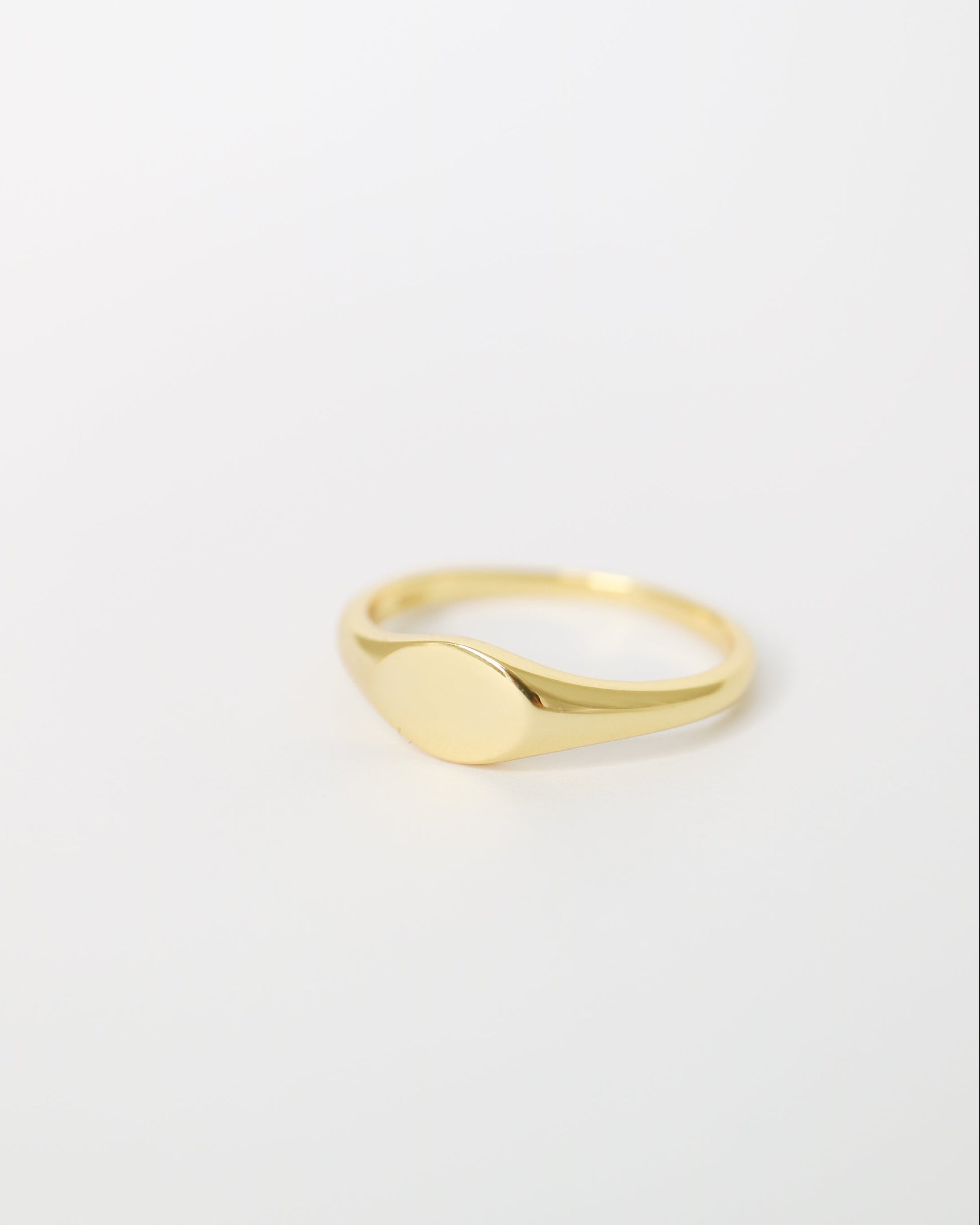 Gold ring on a light gray background