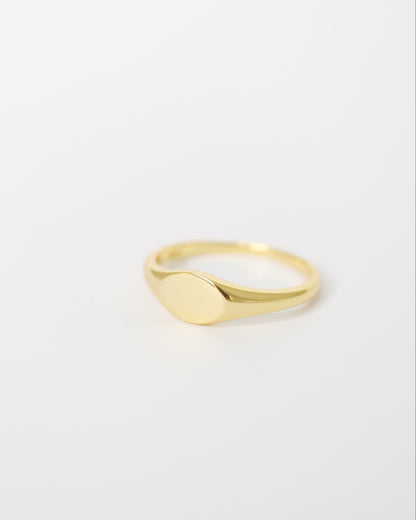 Gold ring on a light gray background