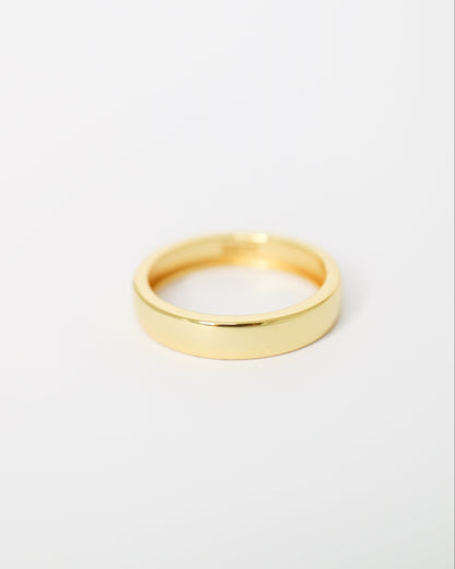 Gold ring on a light gray background
