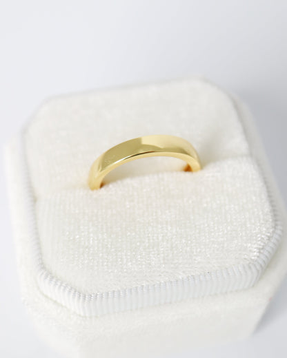 Gold ring on a white textured surface