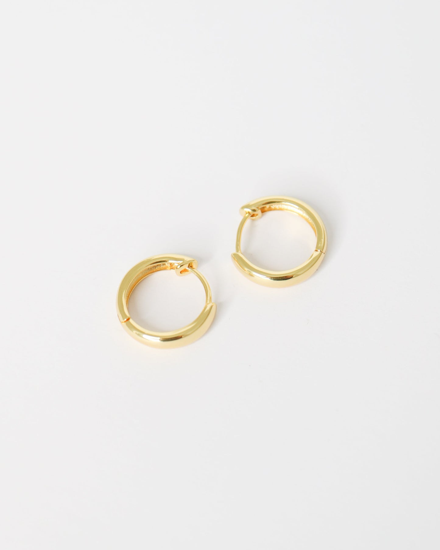 Gold hoop earrings on a white background