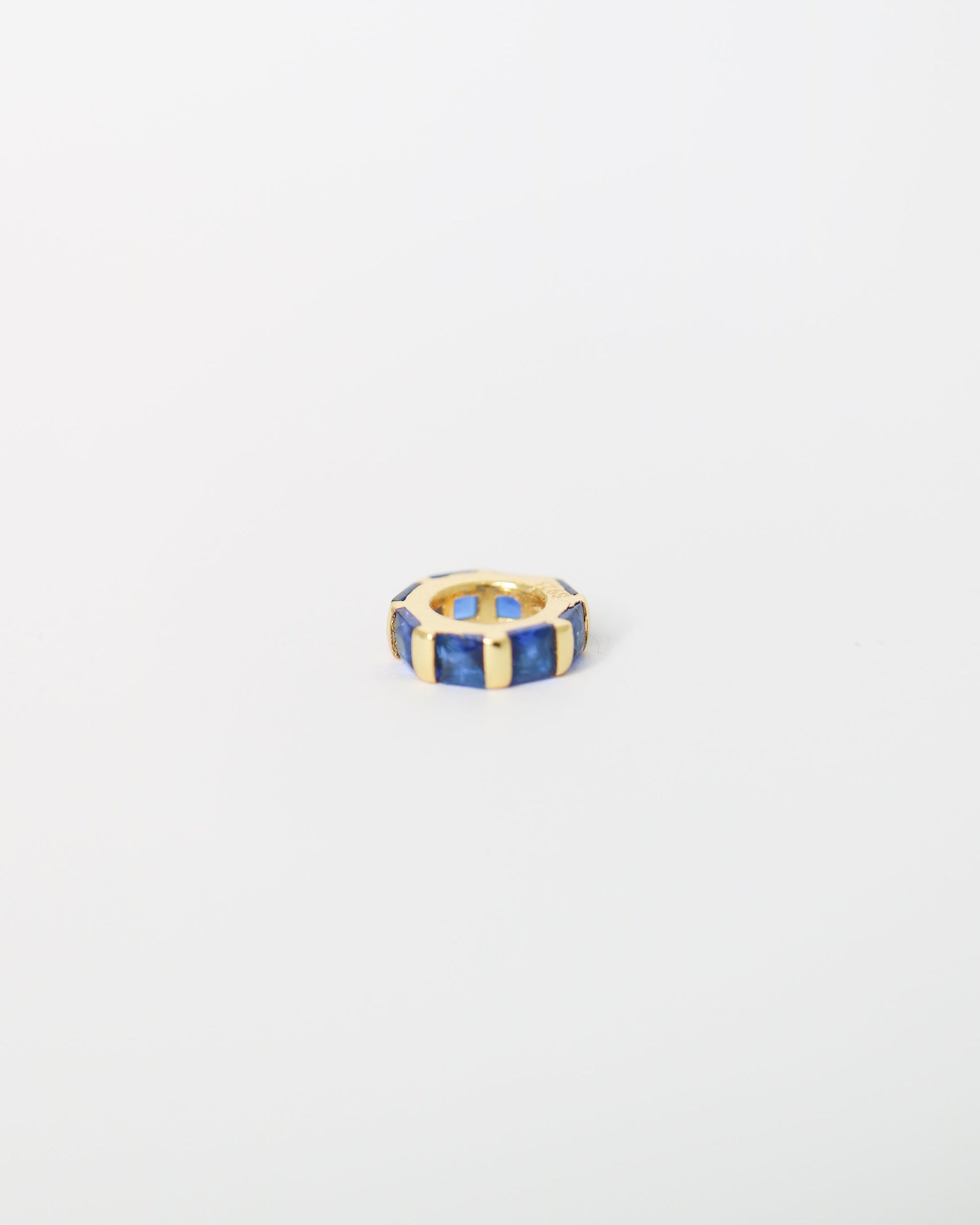 Hexagonal ring with blue and gold accents on a light gray background