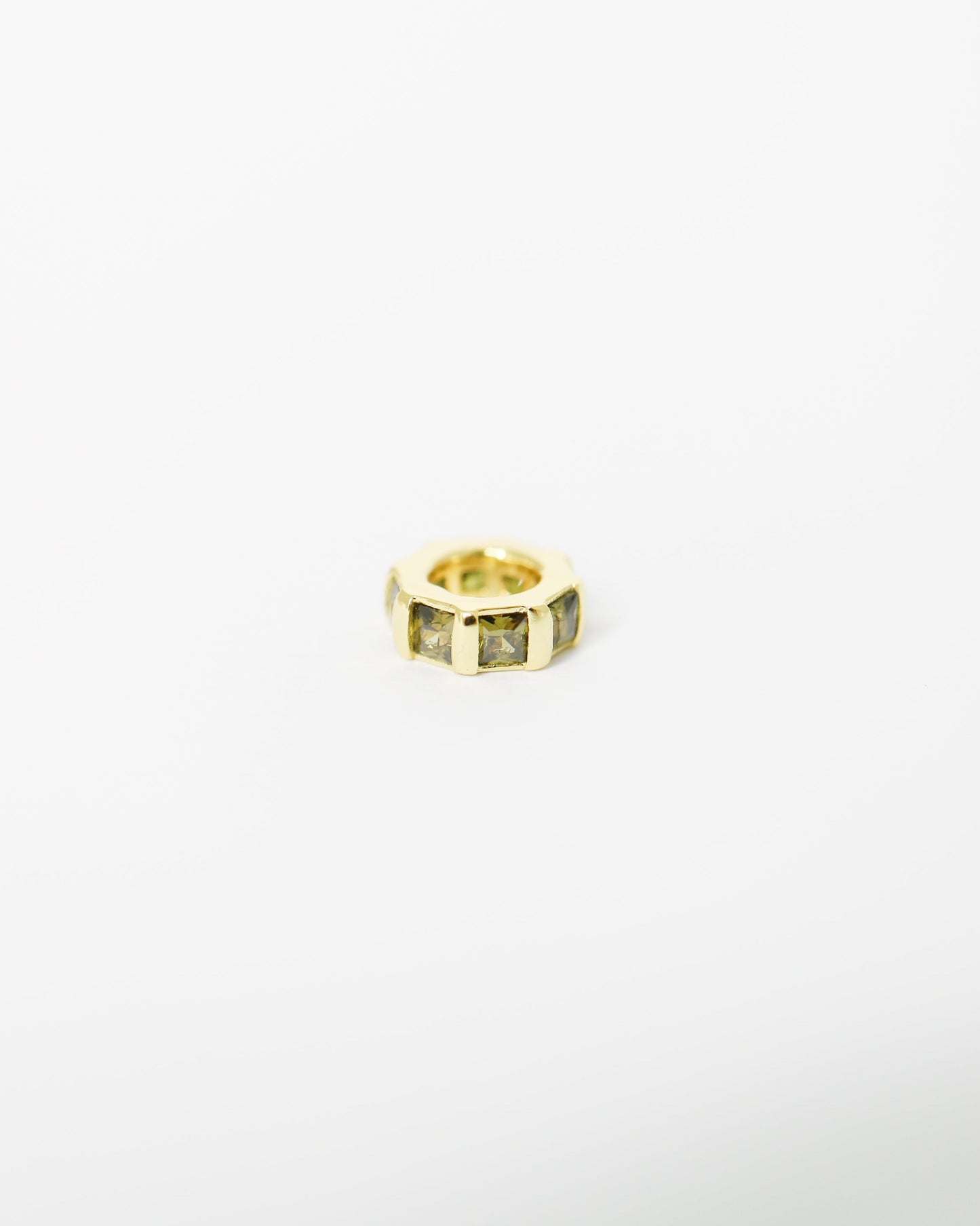 Gold ring with embedded stones on a white background