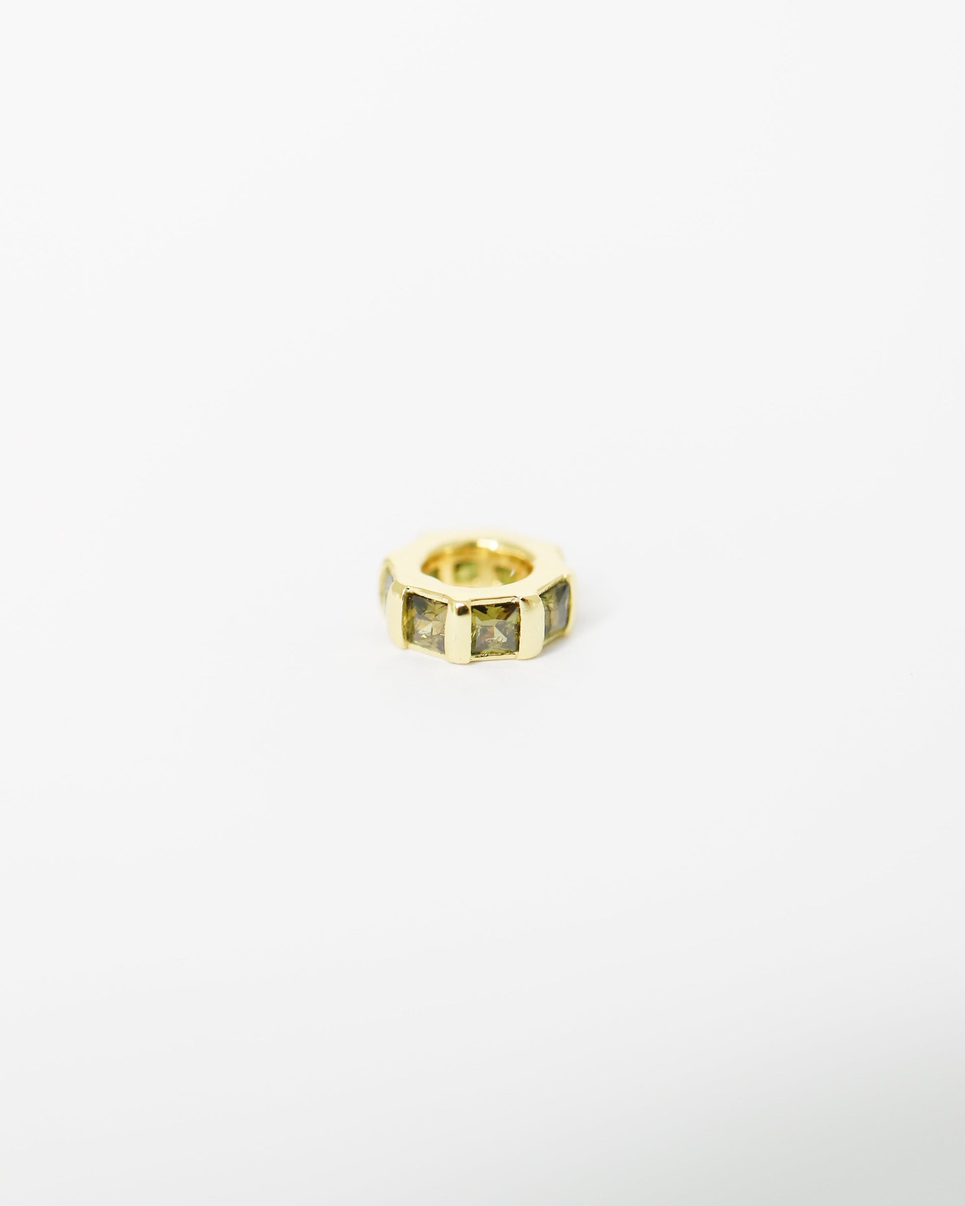 Gold ring with embedded stones on a white background