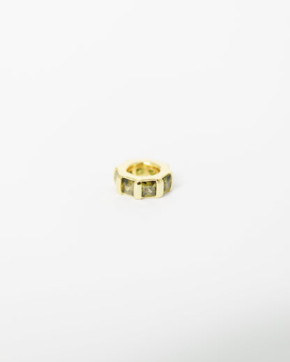 Gold ring with embedded stones on a white background