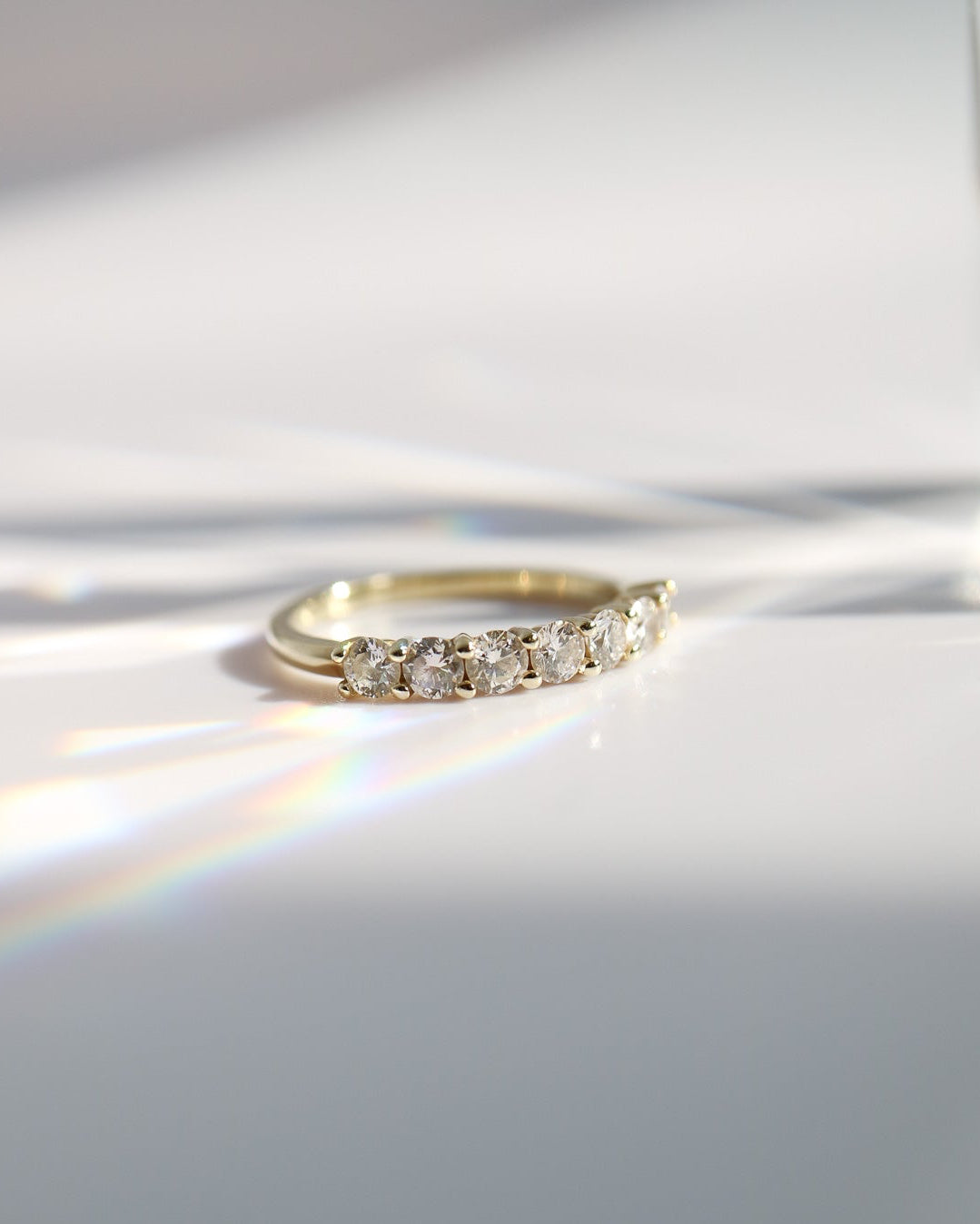 Gold ring with diamonds on a white surface
