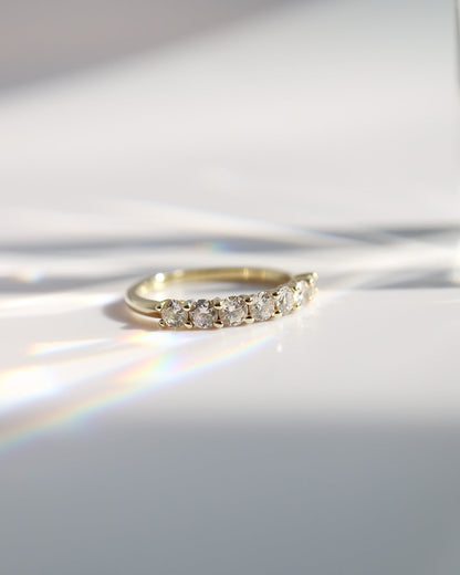 Gold ring with diamonds on a white surface