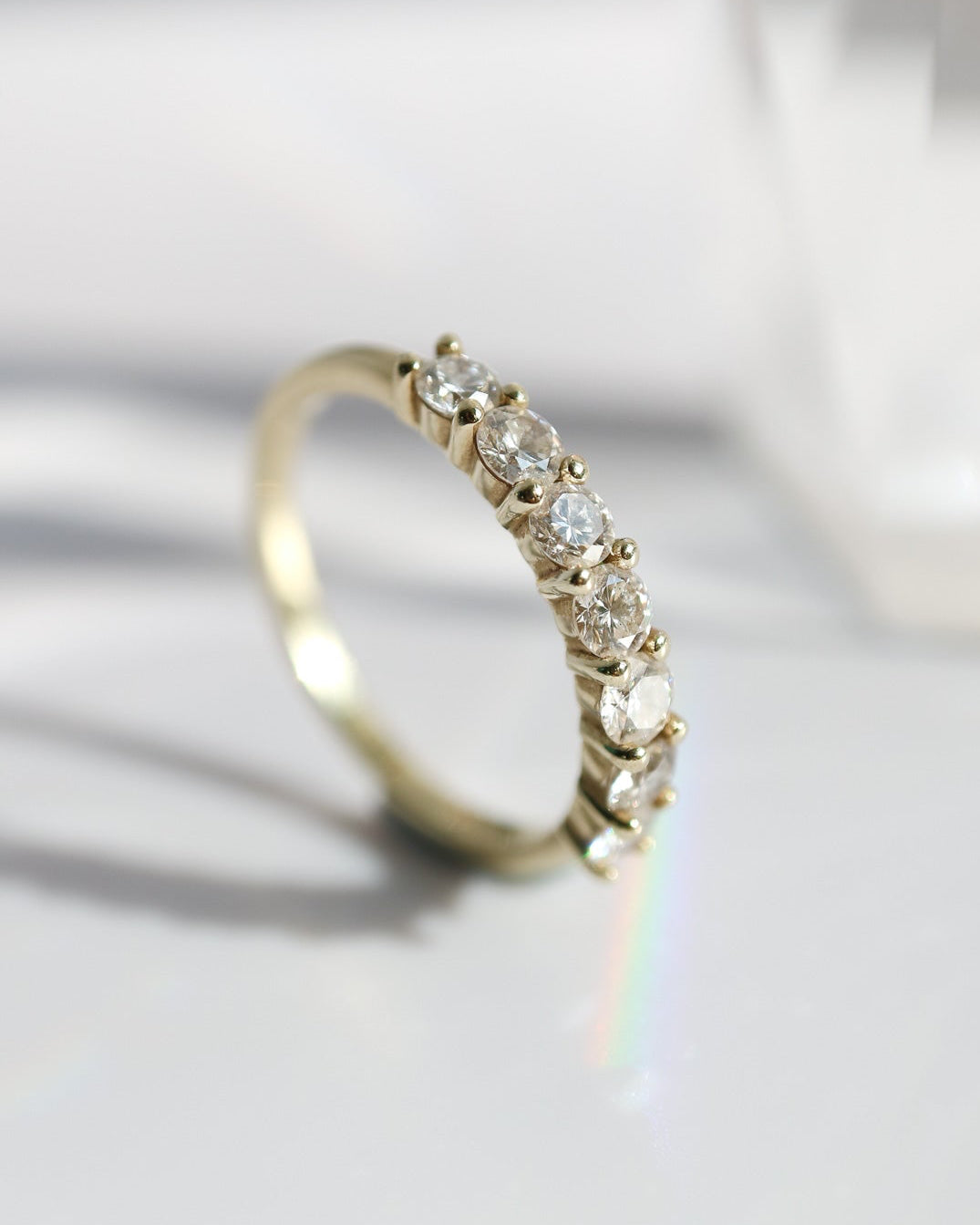 Gold ring with diamonds on a light background