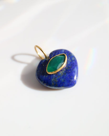 Heart-shaped pendant with green stone and gold accents on a white background