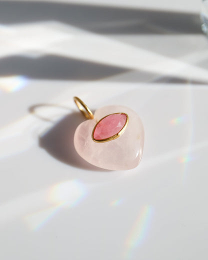 Pink pendant with gold accent on a white surface