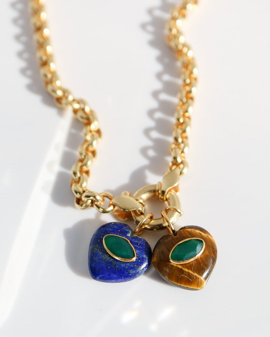 Two gold necklaces with heart-shaped charms on a white background
