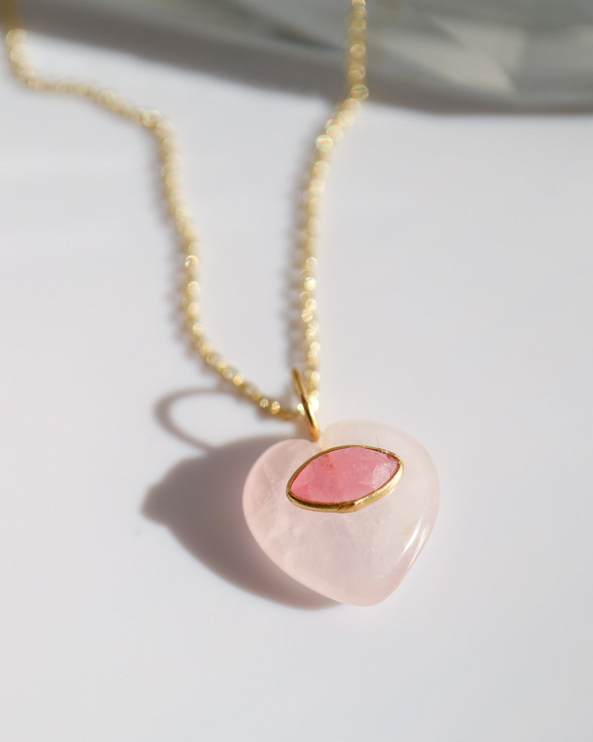 Necklace with a heart-shaped pink pendant on a white background