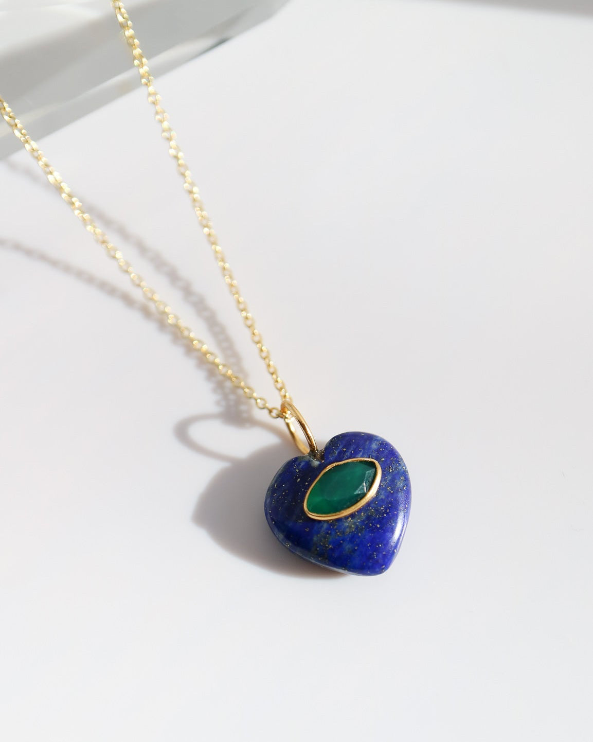 Necklace with a blue heart-shaped pendant on a white background