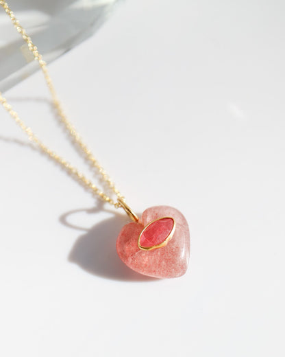 Necklace with a pink heart-shaped pendant on a white background