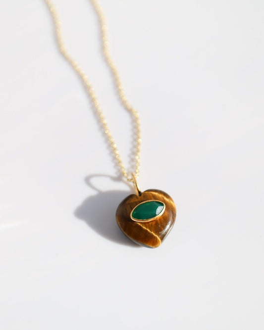 Necklace with a heart-shaped pendant featuring a green stone on a white background