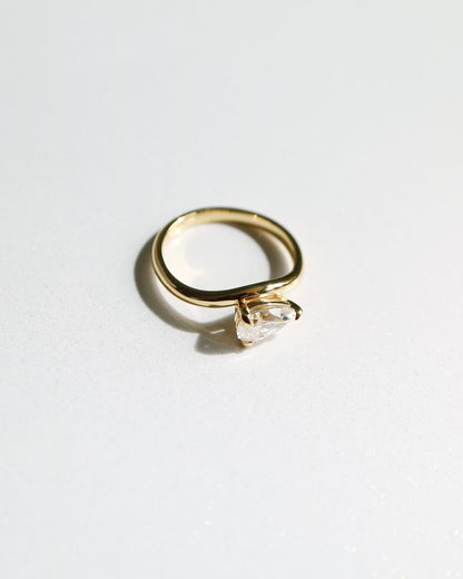Gold ring with a diamond on a white background