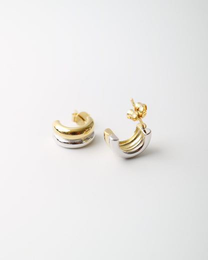 Interlude Hoops featuring a sculptural mixed-metal design with polished gold plated and sterling silver bands and butterfly back fastenings.