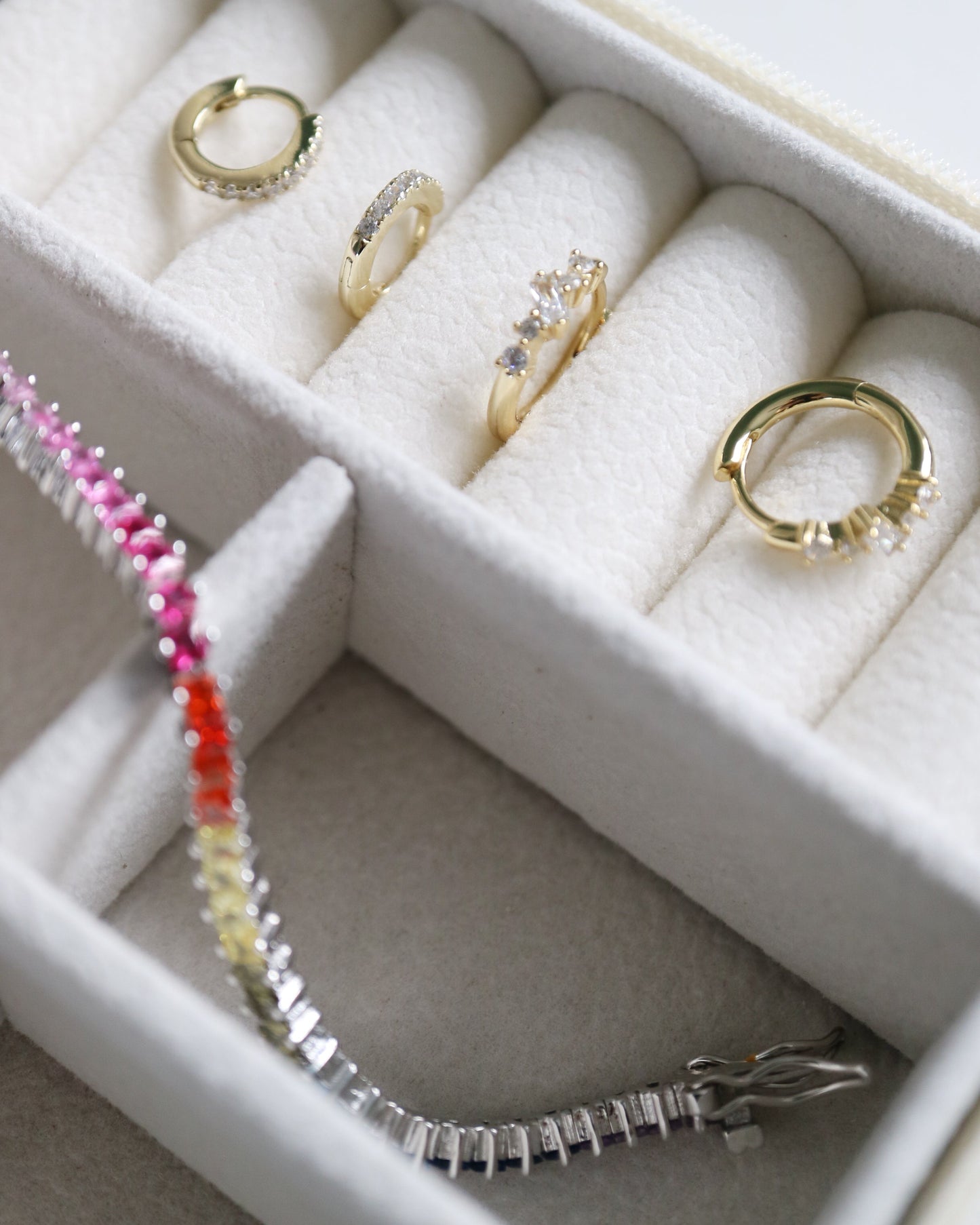 Jewelry set including rings and a bracelet in a white jewelry box.