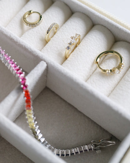 Jewelry set including rings and a bracelet in a white jewelry box.
