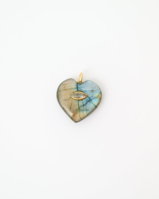 Heart-shaped pendant with a multicolored stone on a white background