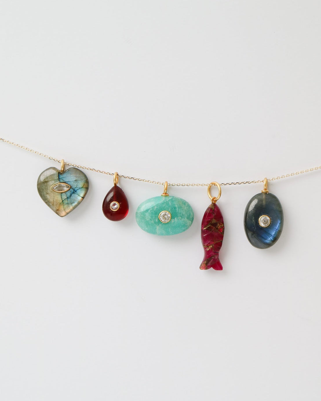 String of colorful stone pendants on a white background