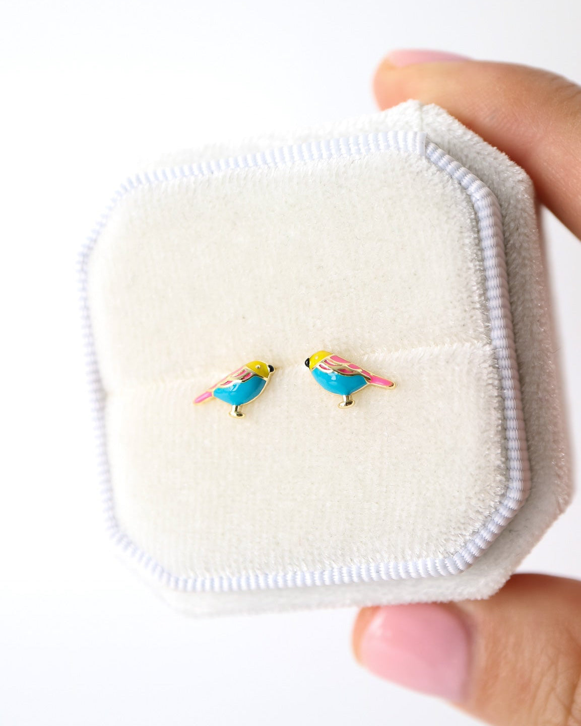 Lovebird stud earrings in silver, presented in a white velvet ring box