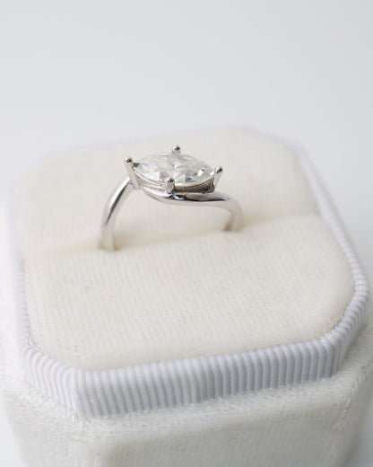 Diamond ring in a heart-shaped box on a white background
