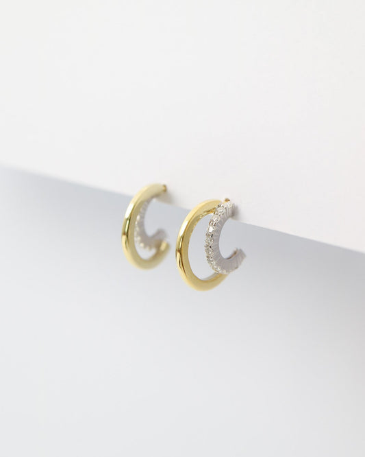 Gold hoop earrings on a white background