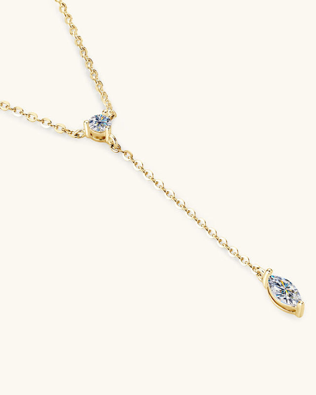 Gold necklace with two diamond pendants on a white background